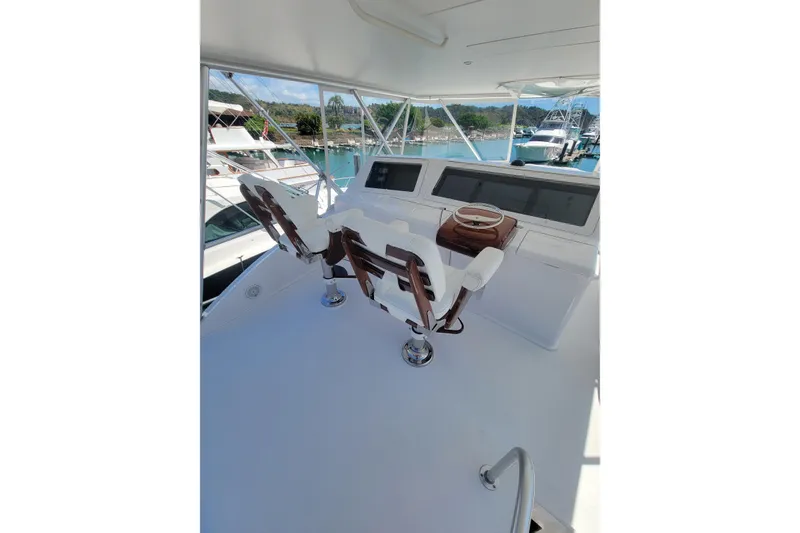 Slide: The Image of 2012 Viking 64c yacht helm with dual captain chairs and navigation equipment. - 13