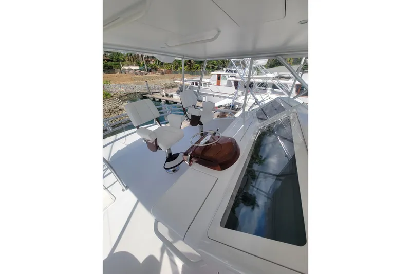 Slide: The Image of Flybridge of 2012 Viking 64c yacht with helm chairs and controls. - 14
