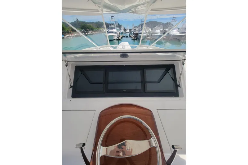 Slide: The Image of 2012 Viking 64c yacht helm with marina view in the background. - 17
