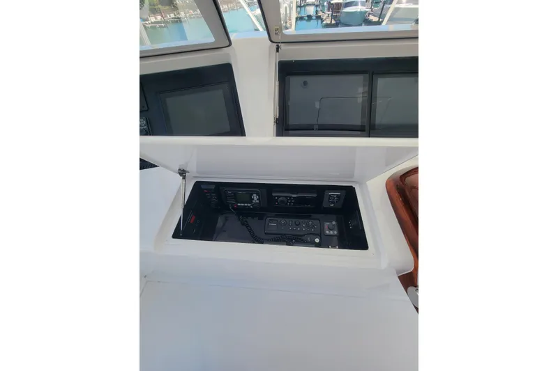 Slide: The Image of Control panel of 2012 Viking 64c yacht, featuring navigation and communication equipment. - 19