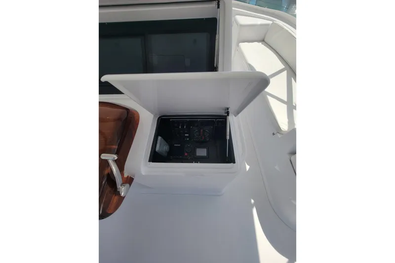 Slide: The Image of 2012 Viking 64c yacht control panel with open cover, showcasing navigation instruments. - 20