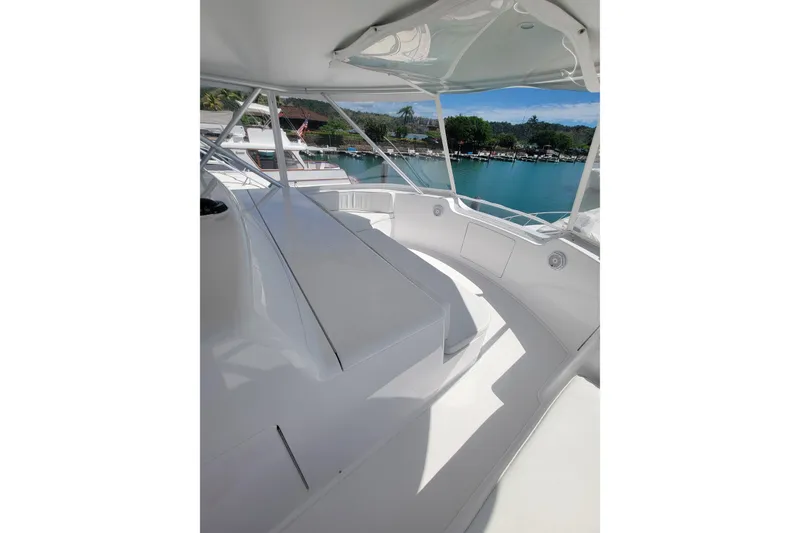 Slide: The Image of Luxurious 2012 Viking 64c yacht interior with sleek white seating and scenic marina view. - 22
