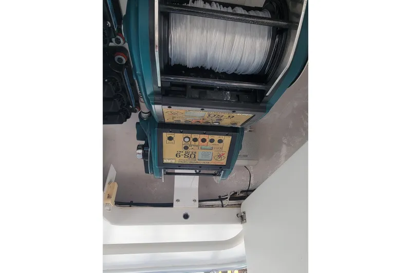 Slide: The Image of Fishing reel equipment on a 2012 Viking 64c boat, featuring control panel and line spool. - 25