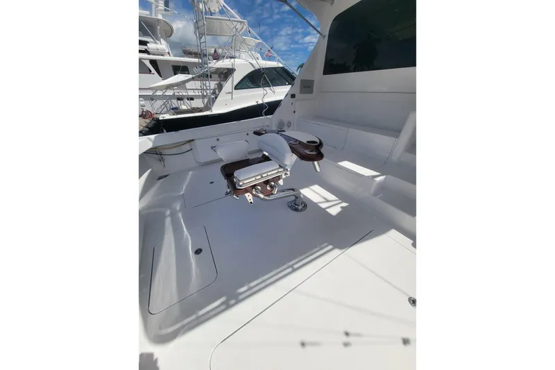 Slide: The Image of Spacious deck of 2012 Viking 64c yacht with fishing chair and clear sky. - 3