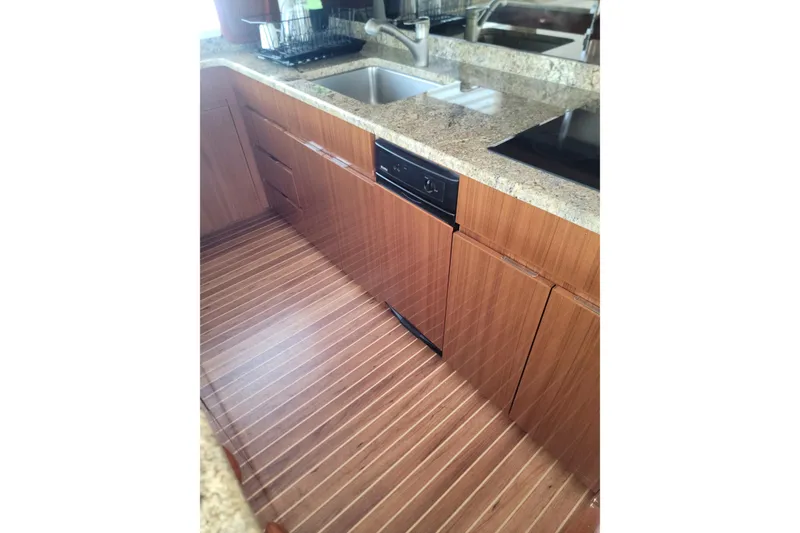 Slide: The Image of Luxurious kitchen interior of 2012 Viking 64c yacht with wooden cabinetry and granite countertops. - 34
