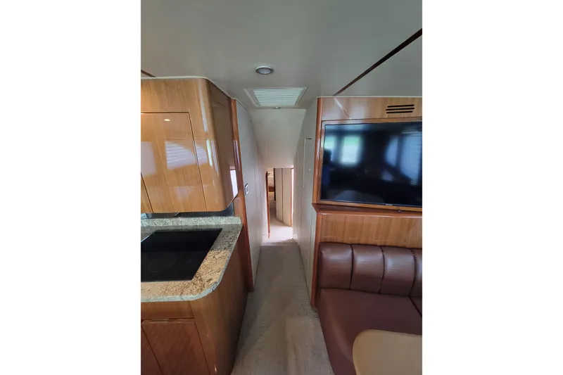 Slide: The Image of Interior of 2012 Viking 64c yacht with modern kitchen and seating area. - 35