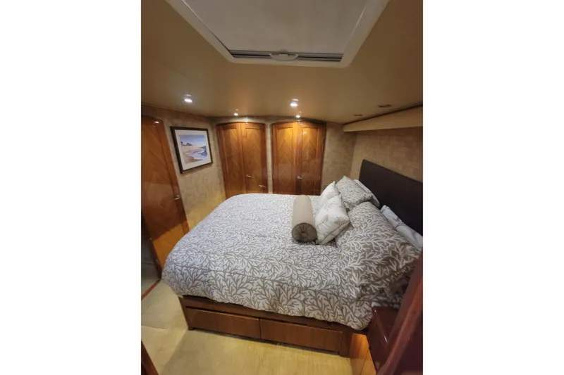 Slide: The Image of Luxurious bedroom interior of 2012 Viking 64c yacht with elegant bedding and wood finishes. - 36