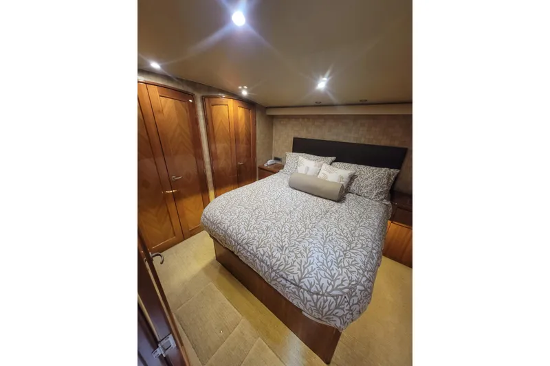 Slide: The Image of Luxurious bedroom interior of 2012 Viking 64c yacht with elegant bedding and wooden cabinetry. - 37