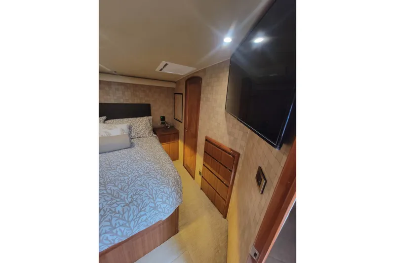 Slide: The Image of Luxurious bedroom interior of 2012 Viking 64c yacht with modern decor and wall-mounted TV. - 39