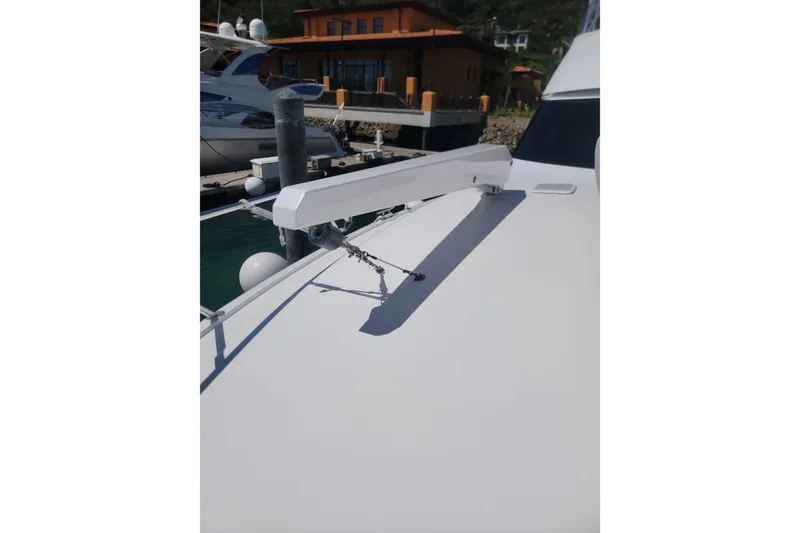 Slide: The Image of 2012 Viking 64c yacht detail with docked boats in background. - 4
