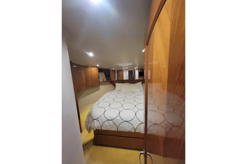 Slide: The Image of Luxurious bedroom interior of 2012 Viking 64c yacht with elegant wood paneling. - 41