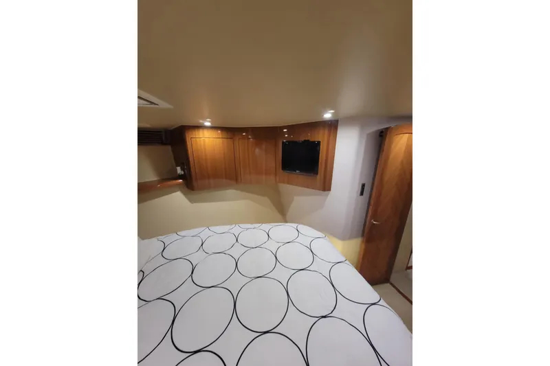 Slide: The Image of Interior of 2012 Viking 64c yacht with modern wood paneling and cozy bedding. - 43
