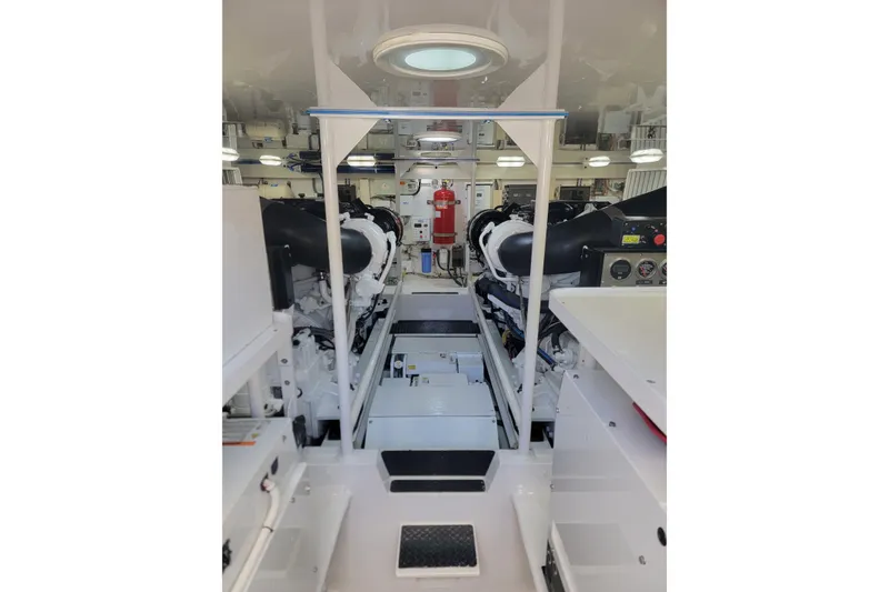 Slide: The Image of Engine room of 2012 Viking 64c yacht, featuring dual engines and control panels. - 48