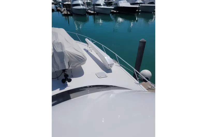 Slide: The Image of Bow view of a 2012 Viking 64c yacht docked in a marina. - 5