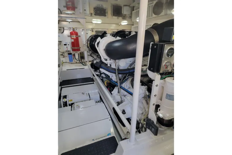 Slide: The Image of Engine room of a 2012 Viking 64c yacht, featuring advanced machinery and equipment. - 51
