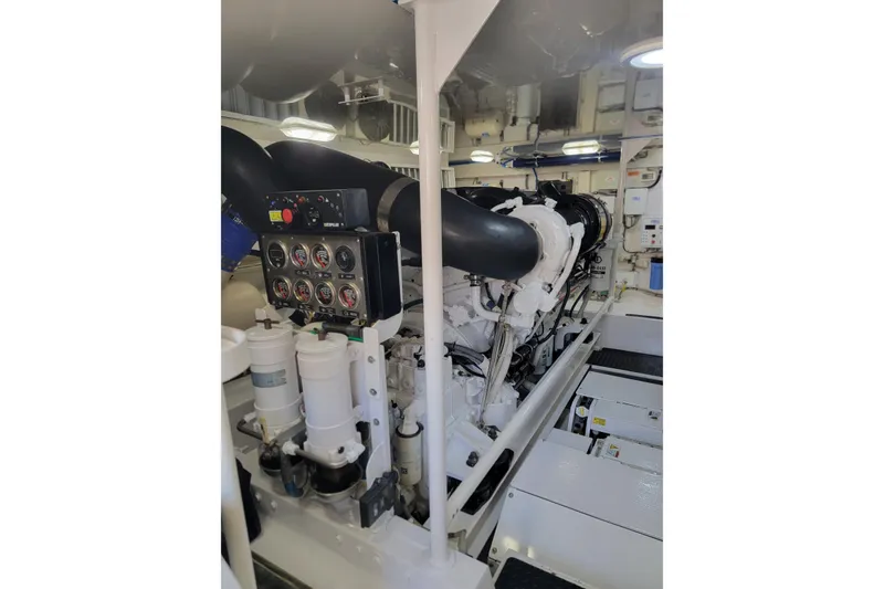 Slide: The Image of Engine room of a 2012 Viking 64c yacht, featuring gauges and machinery. - 52
