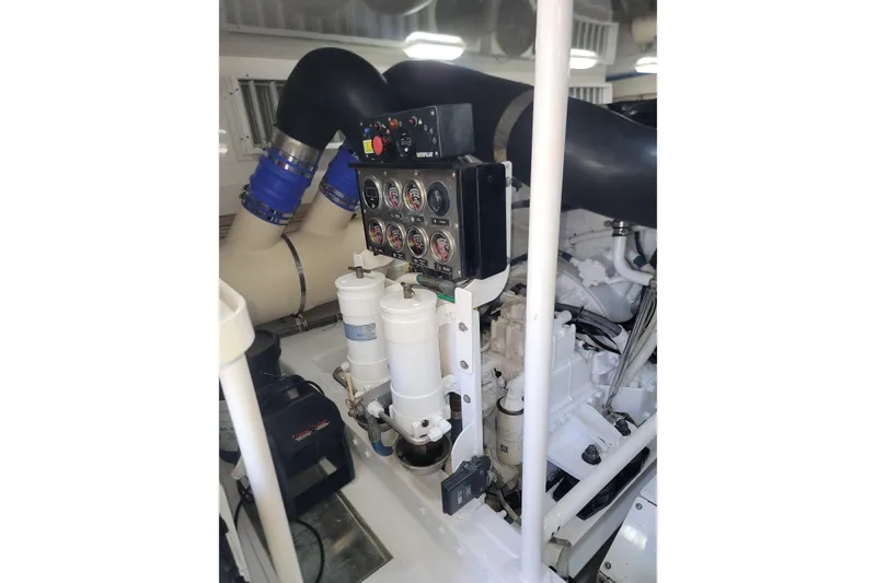 Slide: The Image of Engine room of a 2012 Viking 64c yacht, featuring gauges and filters. - 53