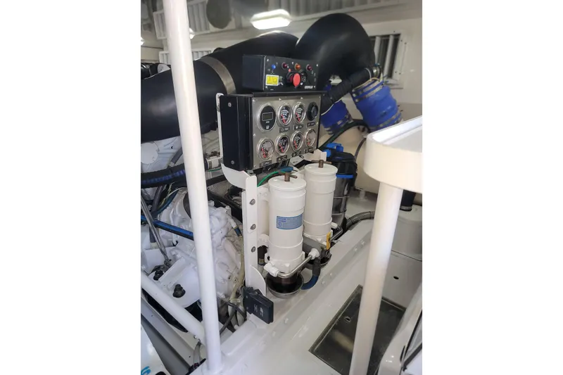 Slide: The Image of Engine room of a 2012 Viking 64c yacht, featuring control panel and filters. - 54