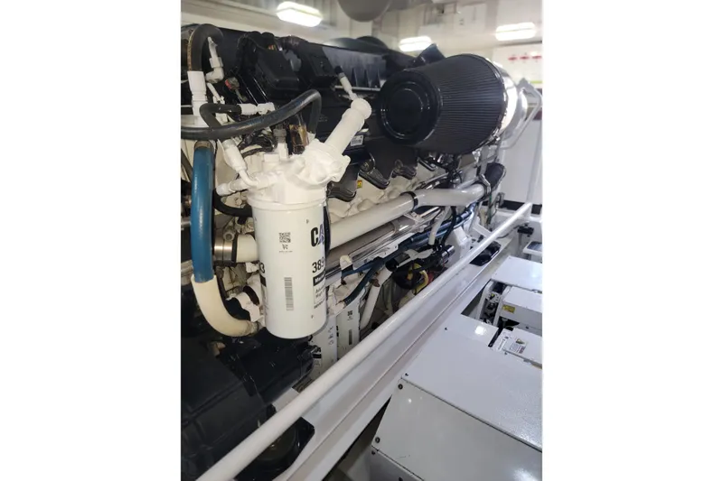 Slide: The Image of Engine compartment of a 2012 Viking 64c yacht, showcasing detailed components and filters. - 56