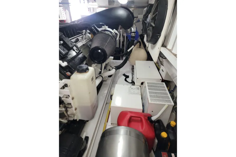 Slide: The Image of Engine room of a 2012 Viking 64c yacht with various mechanical components. - 58