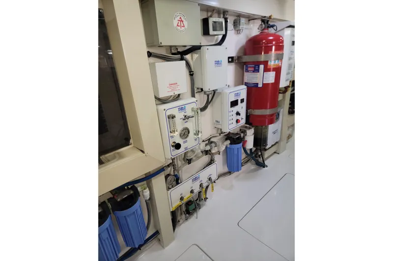 Slide: The Image of Engine room equipment in a 2012 Viking 64c yacht, featuring control panels and safety systems. - 63