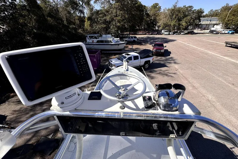 Slide: The Image of 2005 Mirage SF32 Center Console boat dashboard with steering wheel and navigation equipment. - 11