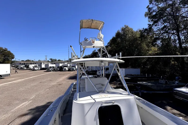 Slide: The Image of 2005 Mirage SF32 Center Console boat in a parking lot with trees and trucks. - 14