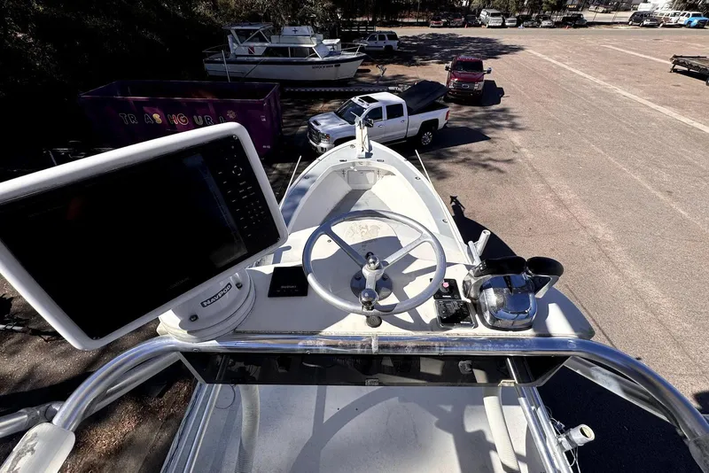 Slide: The Image of 2005 Mirage SF32 Center Console boat with steering wheel and navigation equipment. - 18