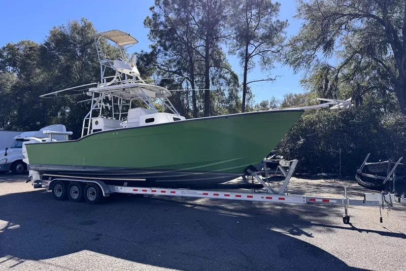 Slide: The Image of 2005 Mirage SF32 Center Console boat on trailer, parked outdoors. - 2