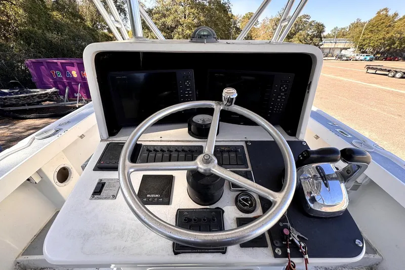 Slide: The Image of 2005 Mirage SF32 Center Console boat dashboard with steering wheel and controls. - 20