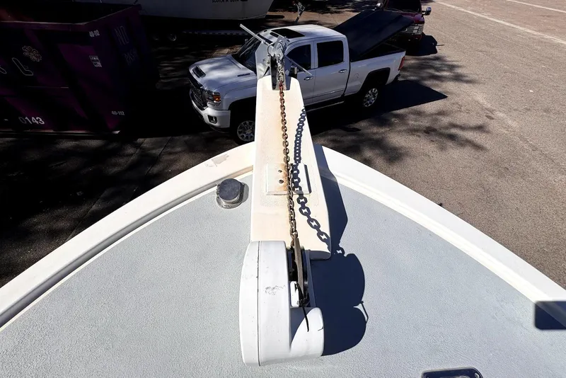 Slide: The Image of Bow of 2005 Mirage SF32 Center Console with anchor chain, parked truck visible. - 25