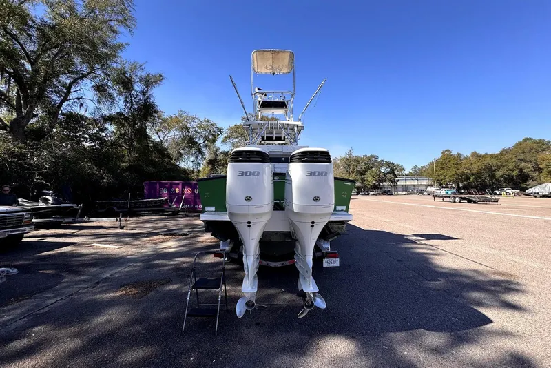 Slide: The Image of 2005 Mirage SF32 Center Console boat with dual 300 horsepower engines, parked outdoors. - 27