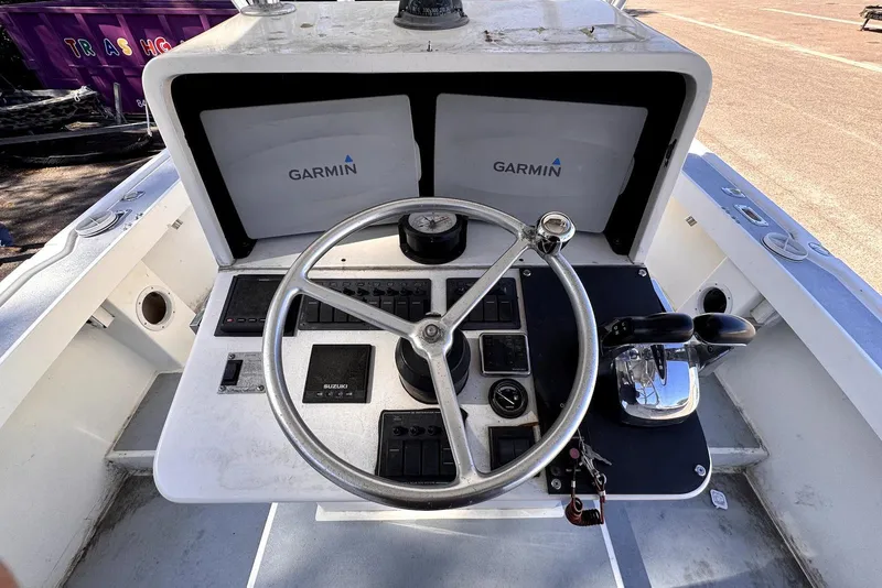 Slide: The Image of 2005 Mirage SF32 Center Console boat dashboard with Garmin navigation system. - 31