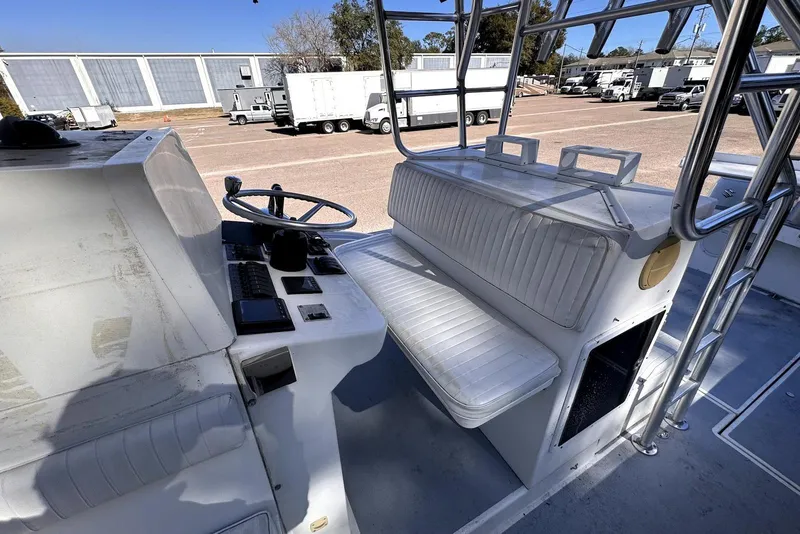 Slide: The Image of 2005 Mirage SF32 Center Console boat interior with steering wheel and seating. - 34