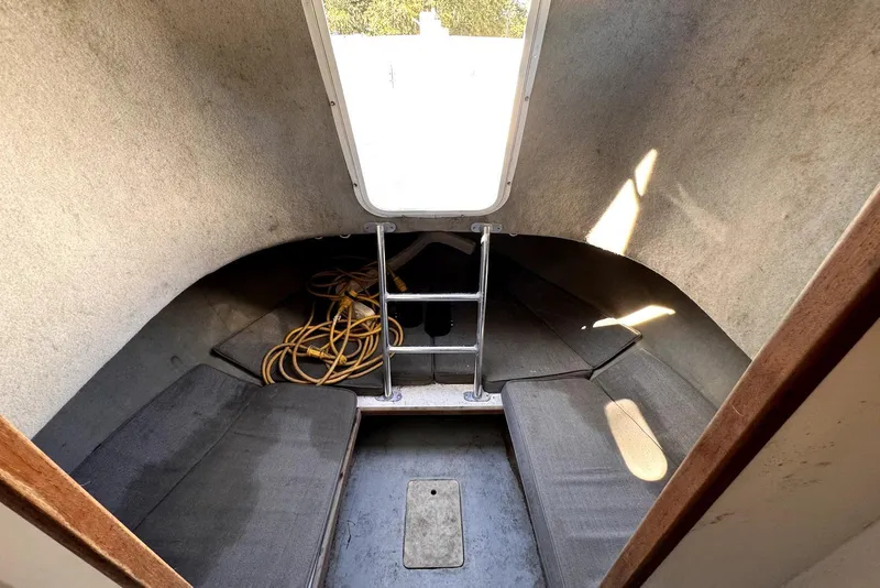 Slide: The Image of 2005 Mirage SF32 Center Console cabin interior with seating and ladder. - 35