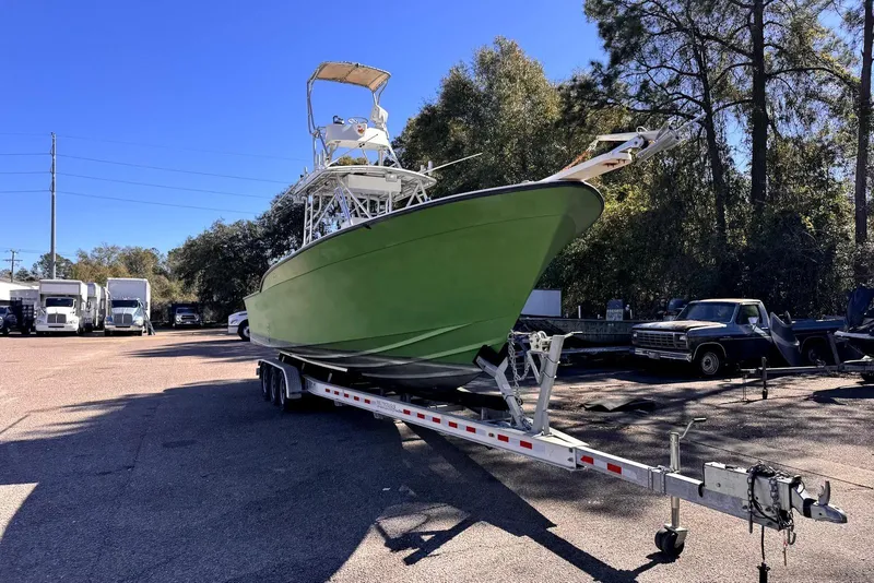 Slide: The Image of 2005 Mirage SF32 Center Console boat on trailer in parking lot. - 5