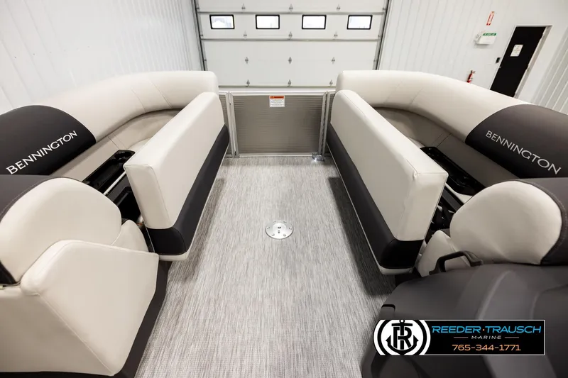 Slide: The Image of 2026 Bennington 22 SSRSF pontoon boat interior with plush seating in a showroom. - 20