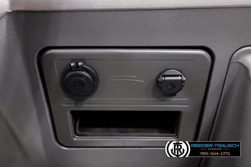 Slide: The Image of 2026 Bennington 22 SSRSF dashboard with 12V marine power outlets. - 35