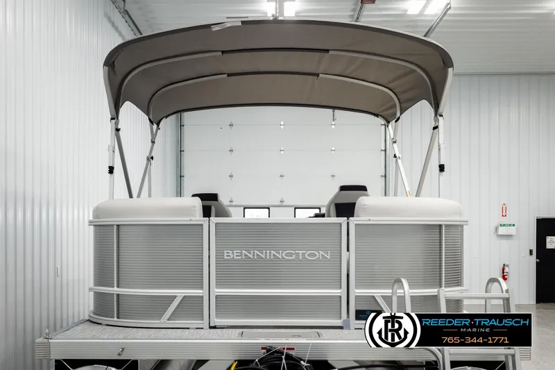 Slide: The Image of 2026 Bennington 22 SSRSF pontoon boat in a showroom with canopy. - 7