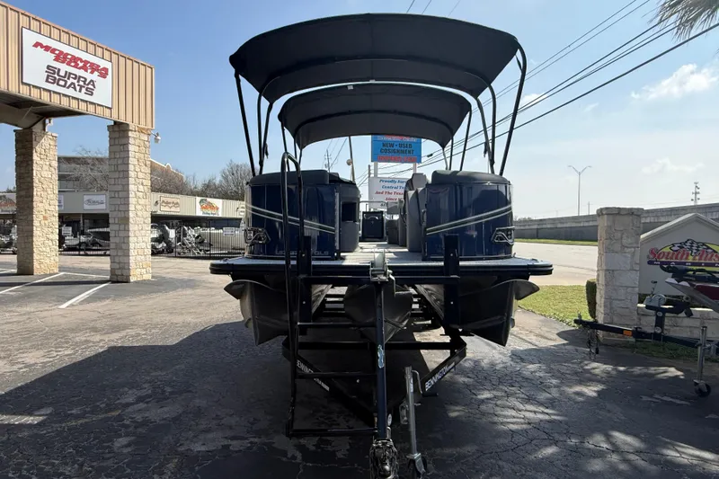 Slide: The Image of 2026 Avalon LSZ 25 Quad Lounge pontoon boat at dealership, rear view. - 1