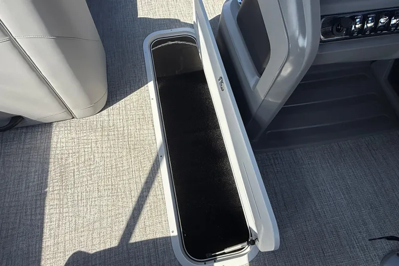 Slide: The Image of 2026 Avalon LSZ 25 Quad Lounge interior storage compartment with gray flooring. - 12