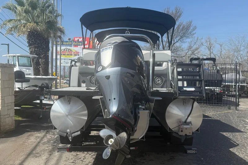 Slide: The Image of 2026 Avalon LSZ 25 Quad Lounge pontoon boat with powerful outboard motor. - 3