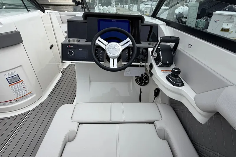 Slide: The Image of The image shows the cockpit of a Sea Ray SDX 290 Outboard boat with modern controls. - 24