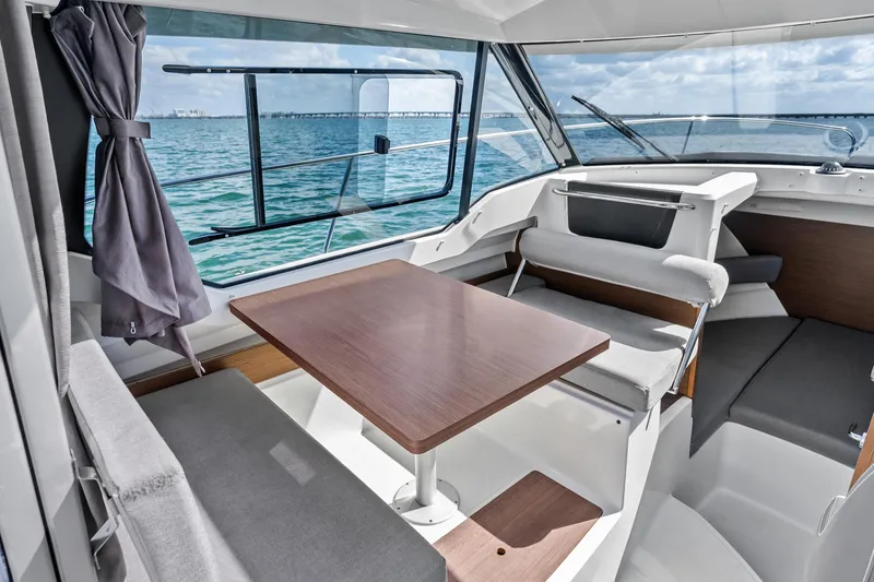 Slide: The Image of Interior of 2019 Jeanneau NC 795 boat with dining area and ocean view. - 14