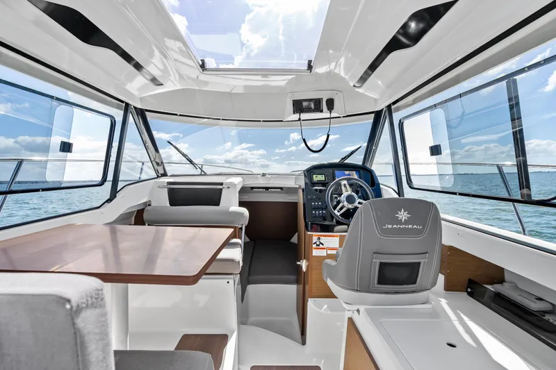 Slide: The Image of Interior of 2019 Jeanneau NC 795 boat with modern helm and seating area. - 16