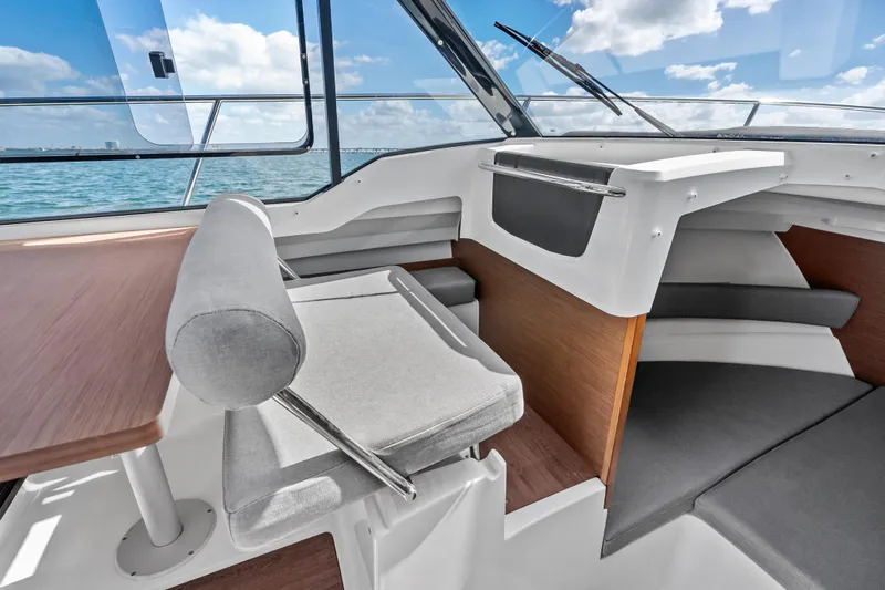 Slide: The Image of 2019 Jeanneau NC 795 boat interior with modern seating and ocean view. - 19