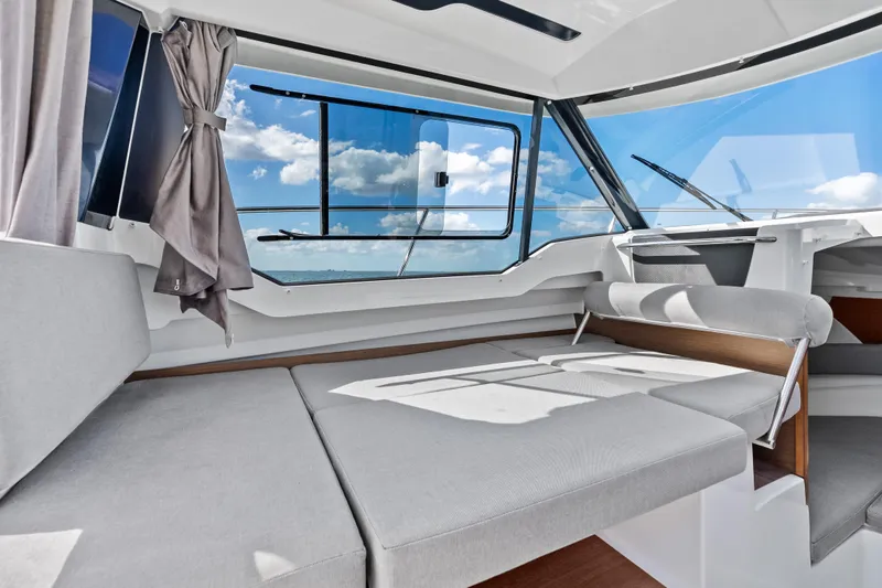 Slide: The Image of Interior of 2019 Jeanneau NC 795 boat with modern seating and large windows. - 21