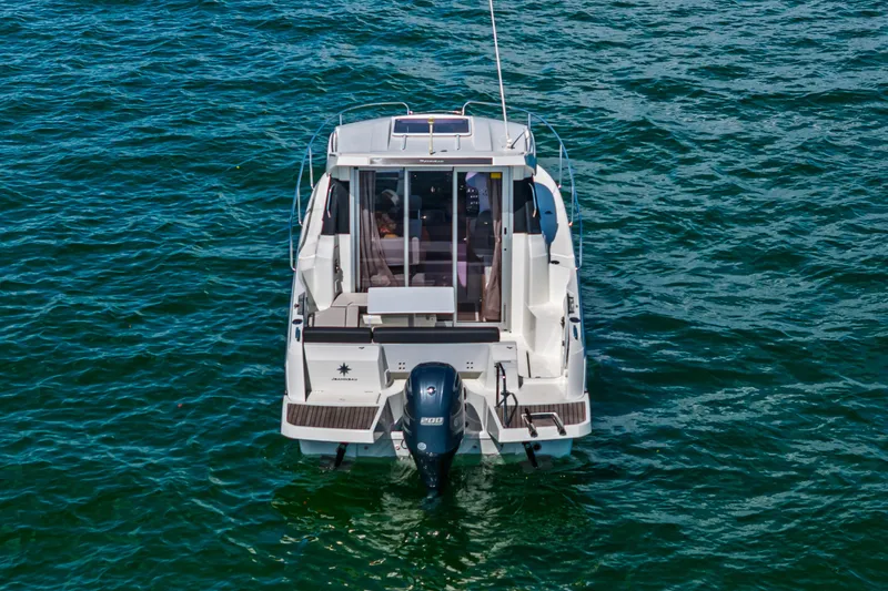 Slide: The Image of 2019 Jeanneau NC 795 boat on open water, rear view. - 3