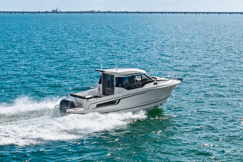 Slide: The Image of 2019 Jeanneau NC 795 motorboat cruising on open water. - 5
