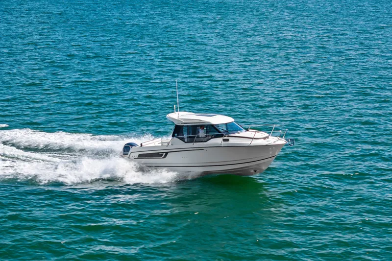 Slide: The Image of 2019 Jeanneau NC 795 motorboat cruising on open water. - 7